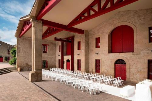 a row of white chairs in a large building at Hotel Marqués de Riscal, a Luxury Collection Hotel, Elciego in Elciego