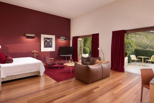 a bedroom with a bed and a living room at Hotel Marqués de Riscal, a Luxury Collection Hotel, Elciego in Elciego