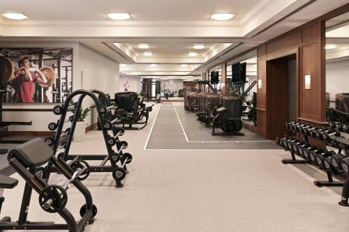 a gym with rows of treadmills and machines at The Ritz-Carlton Abu Dhabi, Grand Canal in Abu Dhabi