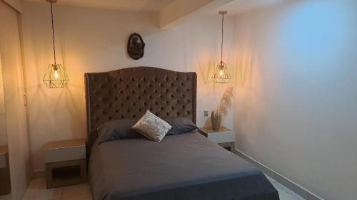 a bedroom with a bed with two pillows on it at amplio y comodo apartamento in Medellín