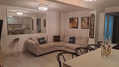 a living room with a couch and a table at amplio y comodo apartamento in Medellín