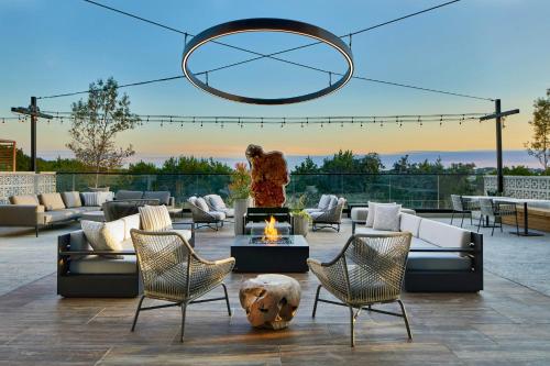 a patio with couches and a fire pit at AC Hotel by Marriott Austin Hill Country in Austin
