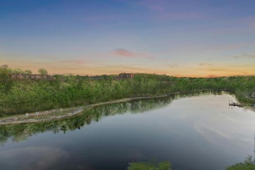 an aerial view of a river at sunset at Merriweather Lakehouse Hotel, Autograph Collection in Columbia