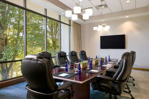 a conference room with a long table and chairs at Merriweather Lakehouse Hotel, Autograph Collection in Columbia