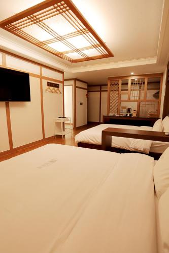 a bedroom with two beds and a skylight at Gyeongju Liebe Stay in Gyeongju