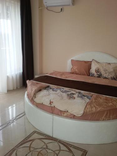 two beds in a room with a bedvisor at Sandanski Peak Guest Rooms in Sandanski