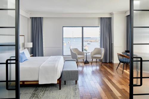 a bedroom with a bed and a view of the water at Annapolis Waterfront Hotel, Autograph Collection in Annapolis