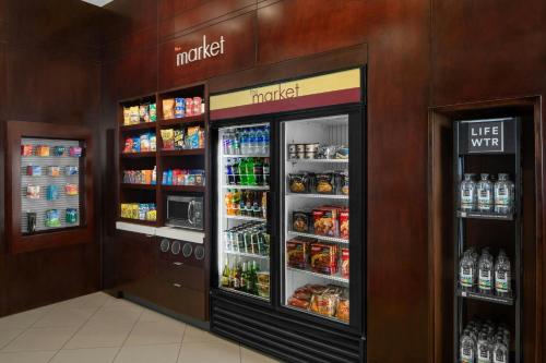 a grocery store with a large refrigerator with drinks at Courtyard Columbia Downtown at USC in Columbia