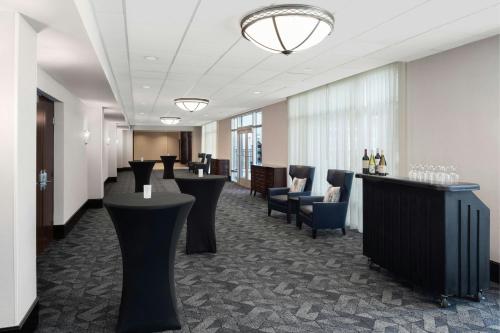 a hotel lobby with a bar and chairs at Courtyard Columbia Downtown at USC in Columbia