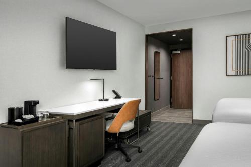 a hotel room with a desk and a bed at Courtyard by Marriott Bozeman in Bozeman