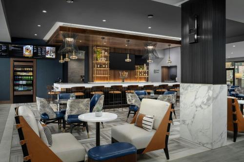 a bar in a restaurant with chairs and a counter at Courtyard by Marriott Bozeman in Bozeman