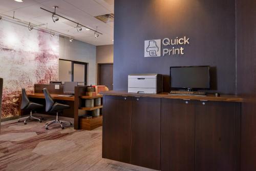 an office with a desk with a computer on it at Courtyard by Marriott Ocala in Ocala