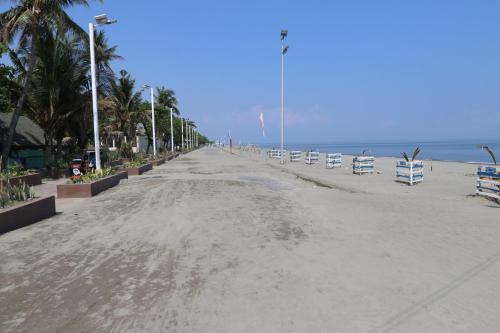 an empty beach with chairs and the ocean at RedDoorz @ Nena's Hotel Dagupan City in Dagupan