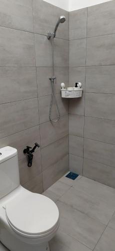 a bathroom with a shower with a toilet in it at Mars Homestay in Alor Setar