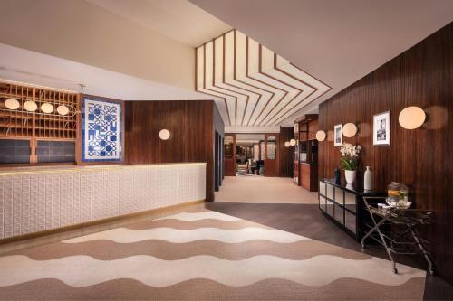 a lobby of a hotel with a reception desk at Hotel Ercilla de Bilbao, Autograph Collection in Bilbao