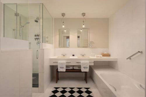 a bathroom with a tub and a sink and a shower at Hotel Ercilla de Bilbao, Autograph Collection in Bilbao