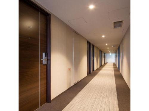 an empty corridor of an office building with a long hallway at New Matto Terminal Hotel - Vacation STAY 01873v in Hakusan