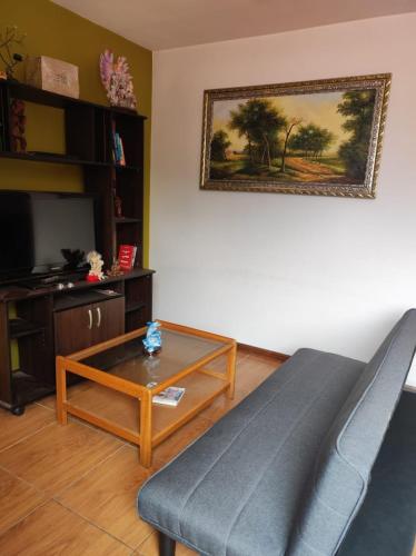 ein Wohnzimmer mit einer Couch und einem Couchtisch in der Unterkunft Habitación cómoda y confortable en el corazón de Puno in Puno