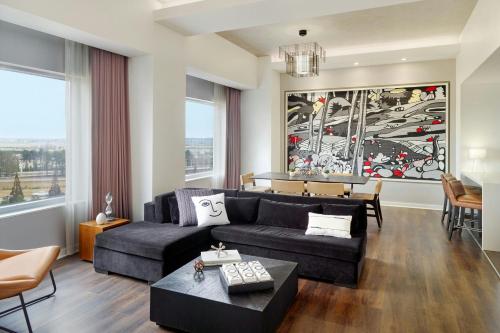 a living room with a couch and a table at Renaissance Atlanta Airport Gateway Hotel in Atlanta