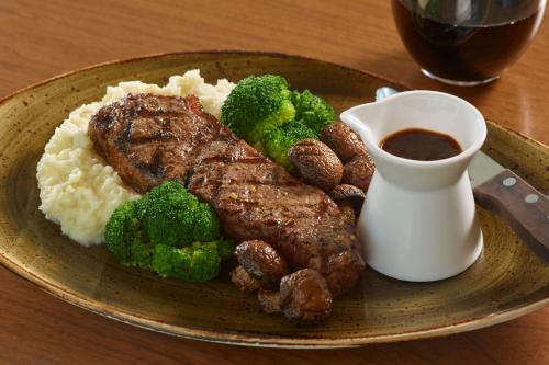 a plate of food with meat and rice and broccoli at Renaissance Atlanta Airport Gateway Hotel in Atlanta