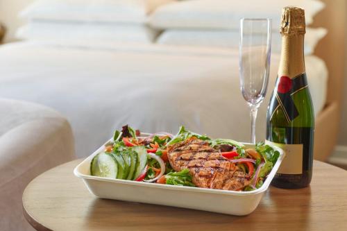 a bowl of food and a bottle of wine on a table at Renaissance Atlanta Airport Gateway Hotel in Atlanta