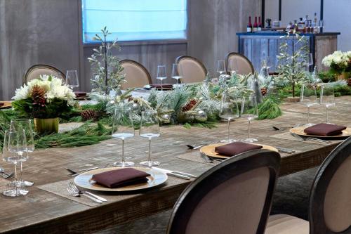 a long wooden table with wine glasses on it at Renaissance Atlanta Airport Gateway Hotel in Atlanta