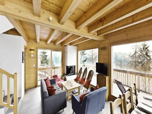 a living room with a couch and chairs at Tranquil chalet with balcony in Plan Fey