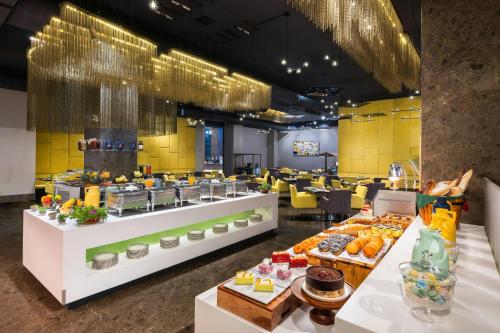 a restaurant with a buffet of food on display at Aloft Bengaluru Outer Ring Road in Bengaluru
