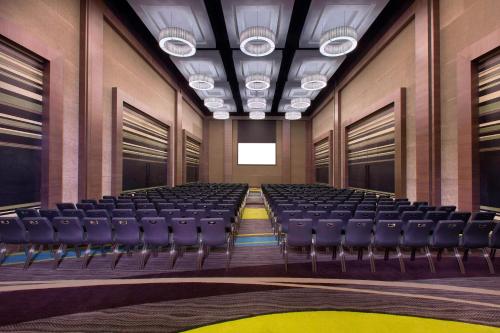 an empty room with chairs in a building at Aloft Bengaluru Outer Ring Road in Bengaluru