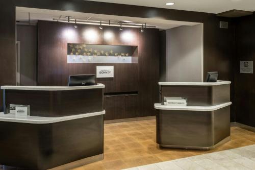a lobby with two reception desks and a laptop at Courtyard by Marriott Boulder Broomfield in Louisville