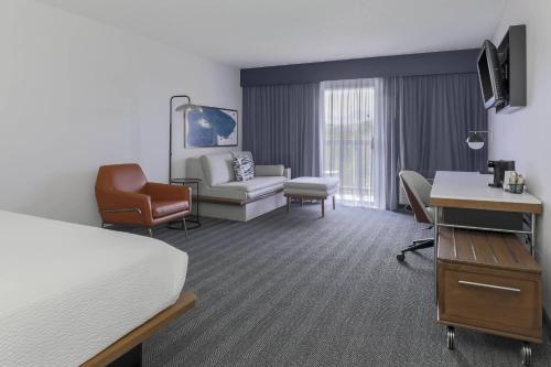 a hotel room with a bed and a desk at Courtyard by Marriott Boulder Broomfield in Louisville