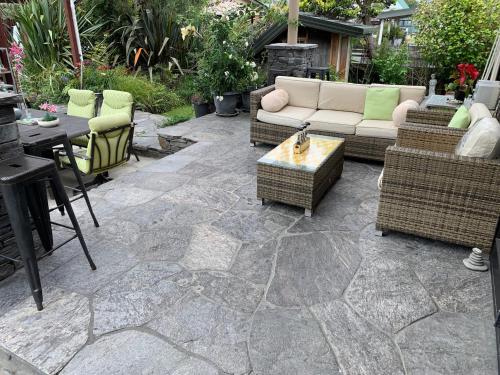 a patio with a couch and chairs and a table at B&B on Park in Hokitika