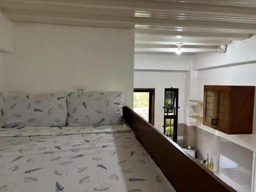 a large bed in a room with a large bed sidx sidx sidx at Budget AC WI-FI Natl Road Ligao City Rm306 in Ligao