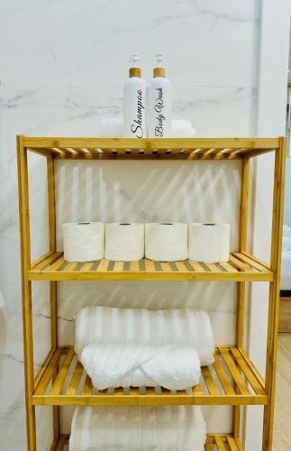 a shelf with towels and toilet paper on it at LOFT 1 - Space & Conform Close To Center in Valencia