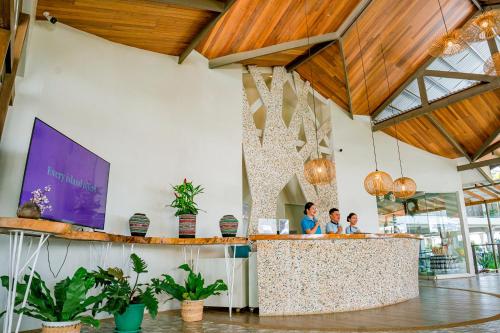 a group of people standing at a counter in a restaurant at Paras Beach Resort - Camiguin in Mambajao