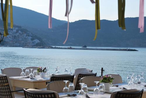 a table set up for a meal with a view of the water at Skopelos Village Hotel in Skopelos Town