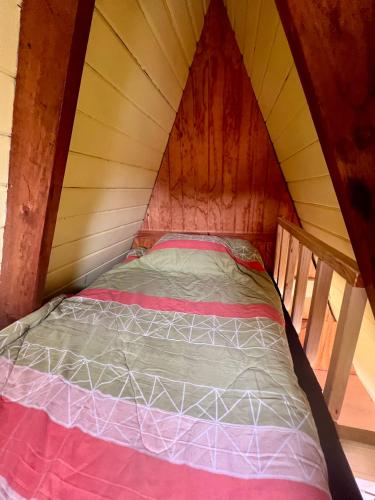 a bed in a room in a tent at Cabaña tipo A Pichidangui in Pichidangui