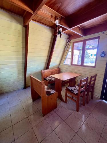 a dining room with a table and chairs in a room at Cabaña tipo A Pichidangui in Pichidangui