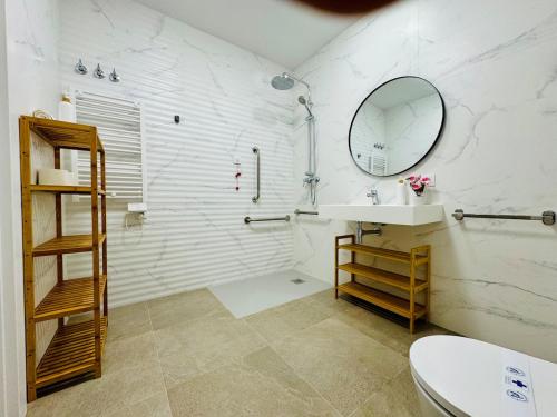 a white bathroom with a sink and a mirror at LOFT 2 - Space & Conform Close To Center in Valencia