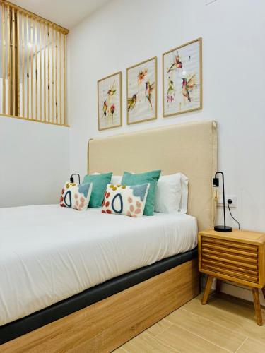 a bedroom with a bed with pillows and a table at LOFT 2 - Space & Conform Close To Center in Valencia