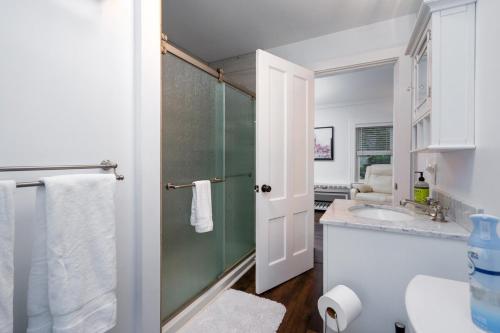 a bathroom with a shower and a sink at 2-Bedroom Apartment, Historic Carriage House in Manchester