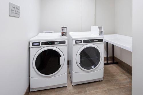 two washing machines and a sink in a room at Courtyard by Marriott Cape Girardeau Downtown in Cape Girardeau