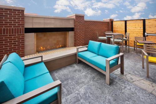 a patio with two blue chairs and a fireplace at Courtyard by Marriott Cape Girardeau Downtown in Cape Girardeau
