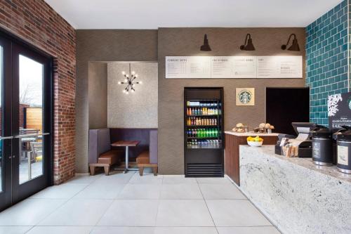 a restaurant with a brick wall and a bar at Courtyard by Marriott Cape Girardeau Downtown in Cape Girardeau
