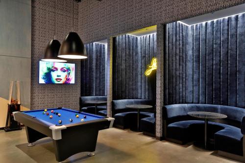 a billiard room with a pool table and chairs at Aloft Chicago Mag Mile in Chicago