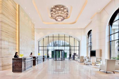 a lobby of a hotel with a chandelier at Courtyard by Marriott Bengaluru Hebbal in Bengaluru