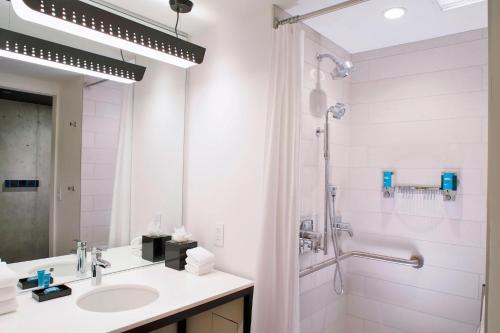 a bathroom with a sink and a shower at Aloft Chicago Mag Mile in Chicago