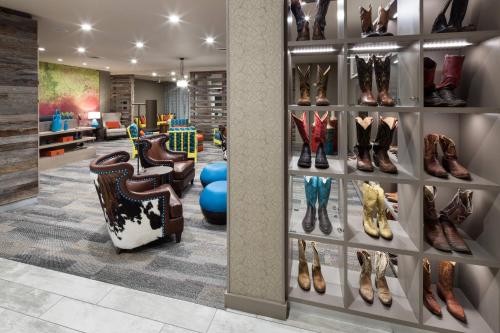 a store with many different types of shoes on shelves at Courtyard by Marriott Fort Worth Historic Stockyards in Fort Worth