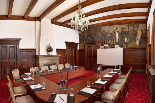 a conference room with a long table and chairs at Falkenstein Grand, Autograph Collection in Königstein im Taunus