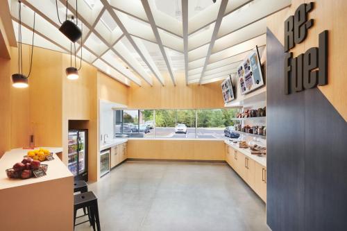 a large kitchen with a high ceiling at Aloft Atlanta Perimeter Center in Sandy Springs
